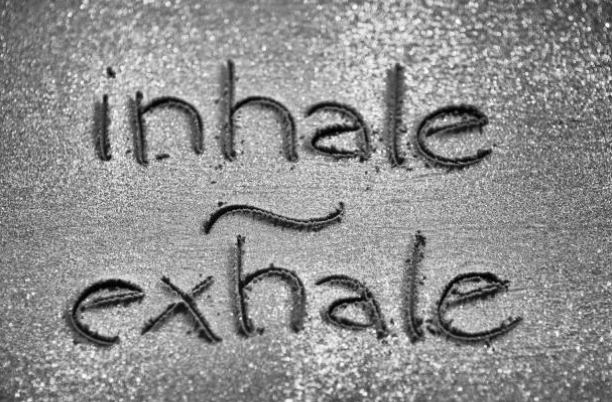inhale exhale written in sand